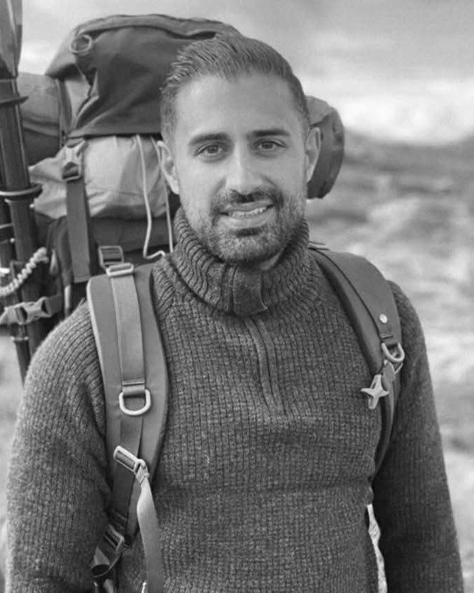 Shayan Kordestani, your guide, with a backpack and packraft paddle
